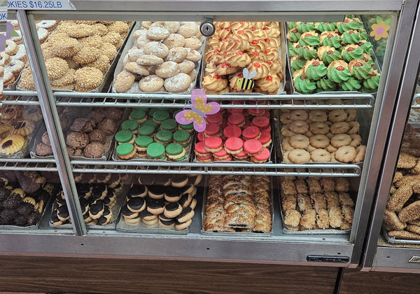 Display case with various types of donuts and pastries