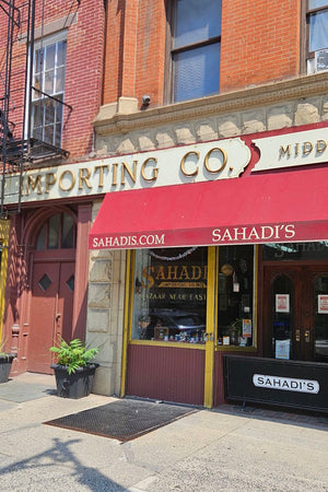 Sahadi Importing Co. building with red awning and storefront entrance.